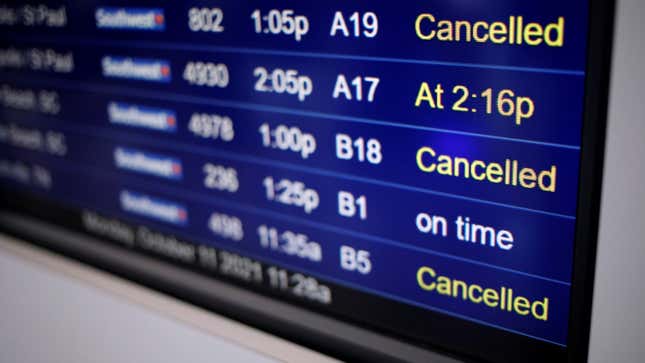 A photo of an airport departure board showing cancelled flights. 