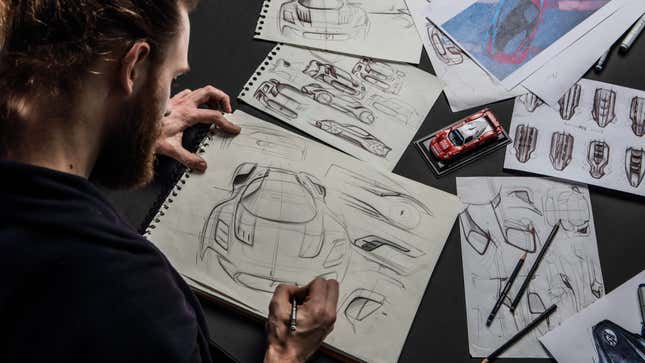 A photo of a designer sketching a car. 