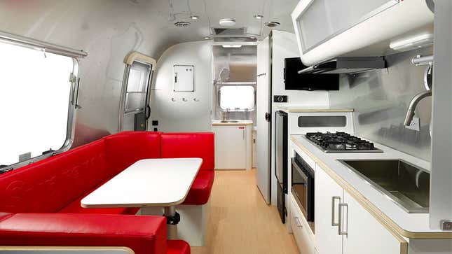 A photo of the kitchen and seating area in the Supreme Airstream.