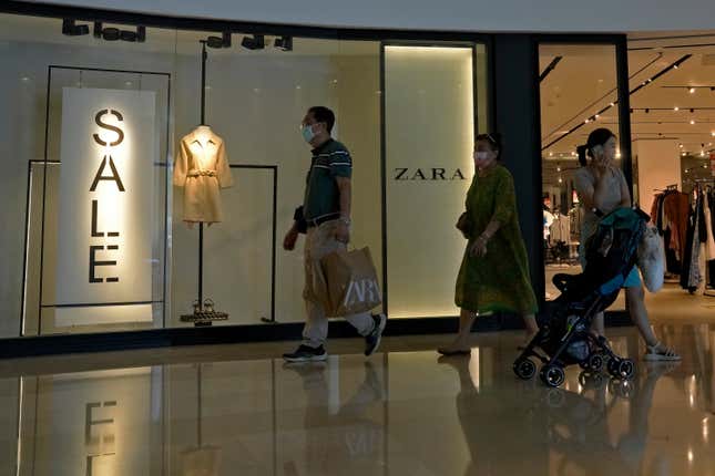 FILE - A man with a shopping bag walks out from a ZARA flagship store at a shopping mall in Beijing, on June 21, 2023. American companies operating in China view tensions with Washington over technology, trade and other issues as a major hindrance for their businesses there, according to a survey by the American Chamber of Commerce in Shanghai. (AP Photo/Andy Wong, File)