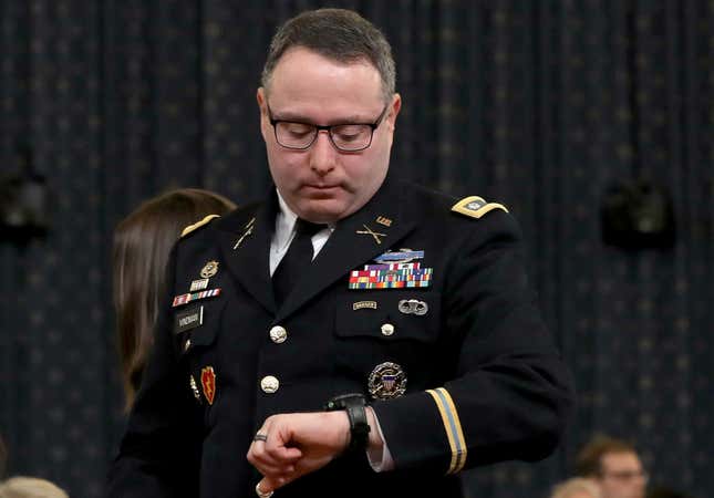  Lt. Col. Alexander Vindman, National Security Council Director for European Affairs, checks his watch as he departs after testifying before the House Intelligence Committee in the Longworth House Office Building on Capitol Hill November 19, 2019 in Washington, DC.