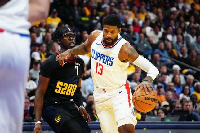 Nov 14, 2023; Denver, Colorado, USA;  LA Clippers forward Paul George (13) drives to the basket against Denver Nuggets guard Reggie Jackson (7) in the second quarter at Ball Arena.