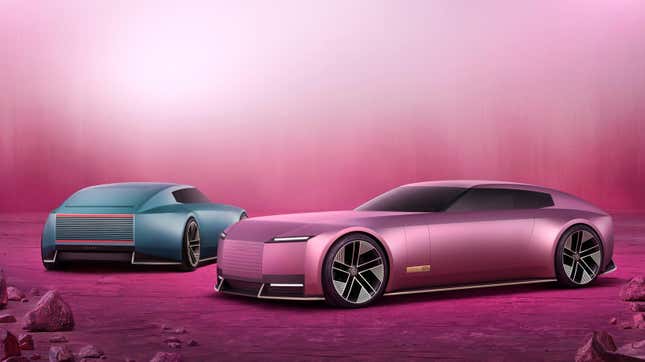 Front 3/4 view of a pink Jaguar Type 00 concept next to a blue Type 00