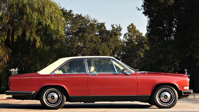 A photo of a red Rolls-Royce Camargue with a white roof.