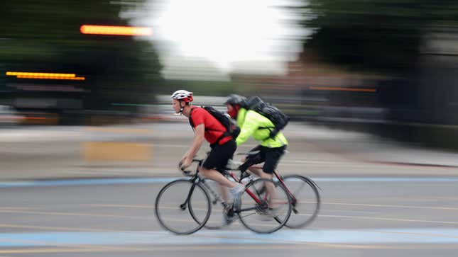 Commuter cyclists make their way through Kennington against a blurred background on Aug. 3, 2016 in London, England.