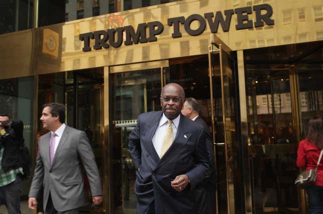 Then-Republican presidential candidate Herman Cain exits Trump Towers to speak with the media before a scheduled appearance with real estate mogul Donald Trump on October 3, 2011 in New York City.