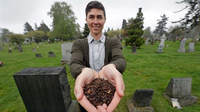 Katrina Spade, the founder and CEO of Recompose, showing off the wood shavings and other plant mulch used to help bodies compost in a photo taken in April 2019