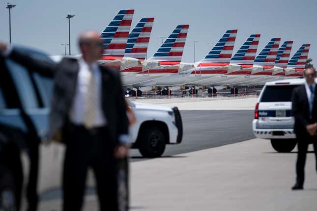 A member of the secret service stands next to President Donald Trump’s limo as unused American Airline jets are seen at Phoenix Sky Harbor Airport during his first trip since widespread COVID-19 related lockdowns went into effect May 5, 2020, in Phoenix, Arizona.