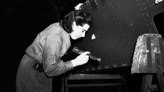 Mrs. Williams on the many works inspectors casting her critical eyes over the work done by her fellow men and women workers on parts for the Halifax bombers, somewhere in England, on April 15, 1942.