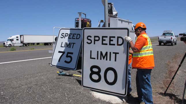 Nevada Department of Transportation crews replace a 75 mph speed limit sign with an 80 mph along U.S. Interstate 80 near Fernley, Nev., about 40 miles east of Reno.