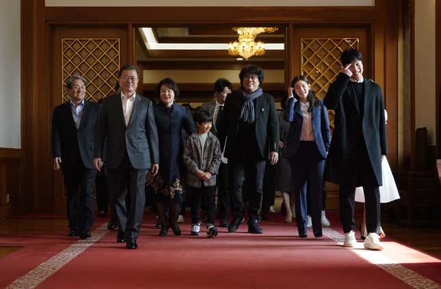 Oscar award-winning film ‘Parasite’ director Bong Joon-ho and South Korean President Moon Jae-in walk for a luncheon at the Presidential Blue House in Seoul on February 20, 2020.