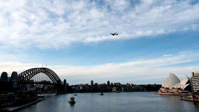 A Qantas Boeing 747 airliner flies over the Sydney Harbor Bridge on July 22, 2020.