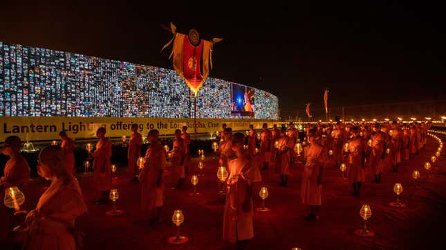 Thai monks walk past a 280-meter-long screen (920 feet) where virtual devotees take part in an online Makha Bucha Day ceremony on February 26, 2021 in Bangkok, Thailand. 