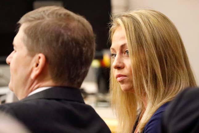 Fired Dallas police officer Amber Guyger looks toward her attorney before proceedings in her murder trial in Dallas