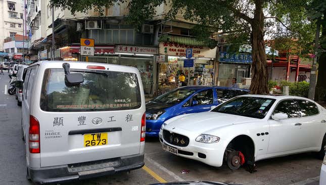 Image for article titled The Most Dedicated Mechanics In The World Wrench On The Streets Of Hong Kong