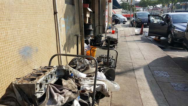 Some parts on the curb, just outside of a shop.