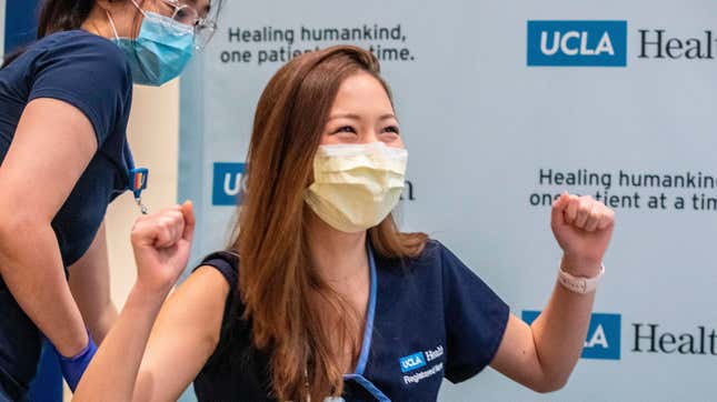 Nurse Nicole Chang celebrates after receiving one of the first injections of the covid-19 vaccine at Ronald Reagan UCLA Medical Center in Westwood, California on December 16, 2020.