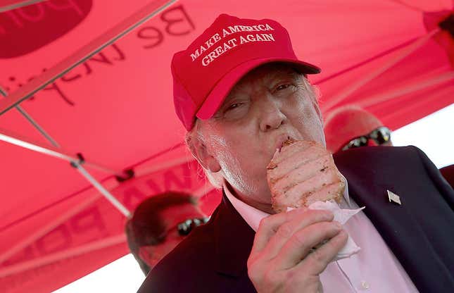 Donald Trump eats a pork chop on a stick and gives a thumbs up sign to fairgoers at the Iowa State Fair on August 15, 2015 in Des Moines, Iowa.