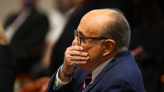 U.S. President Donald Trump’s personal attorney Rudy Giuliani waits to testify before the Michigan House Oversight Committee on December 2, 2020 in Lansing, Michigan.