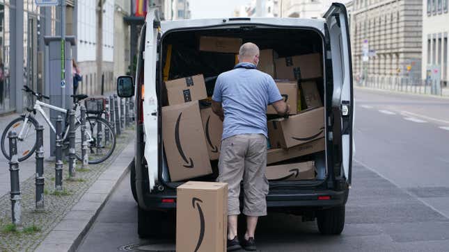 A courier unloads Amazon packages during a delivery on June 18, 2020 in Berlin, Germany.