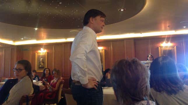 Andrew Wakefield, mid-presentation, listening to a question from an audience member.