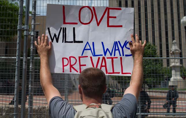 A Protester holds a sign during a counter protest against a rally held by the KKK affiliated group Honorable Sacred Knights of Indiana at Courthouse Square on May 25, 2019 in Dayton, Ohio. 
