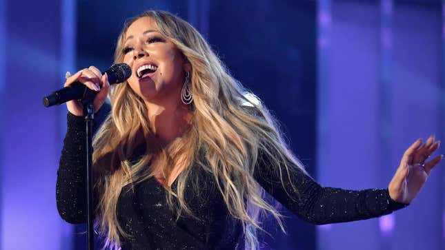 The oracle Mariah Carey, draped in mist, emerges from shrine to speak on Thanksgiving, dog hair