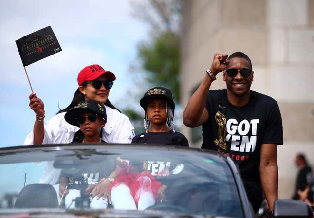 Toronto Raptors President Masai Ujiri and family wave to the crowd during the Toronto Raptors Victory Parade on June 17, 2019 in Toronto, Canada.