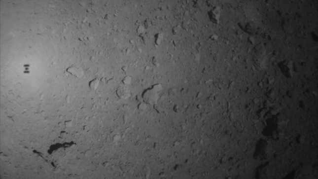 An image taken of the Ryugu asteroid during the recent, unsuccessful attempt to drop a marker on the surface. The shadow of the Hayabusa2 space probe can been seen at left. 