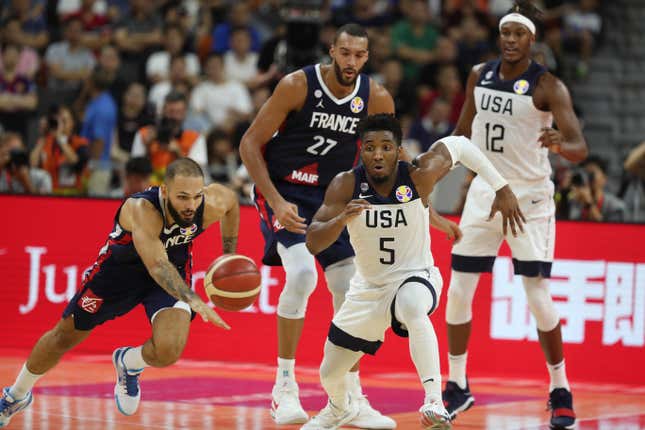 United States’ Donovan Mitchell, center and France’s Evan Fournier at left races for the ball during a quarterfinal match for the FIBA Basketball World Cup in Dongguan in southern China’s Guangdong province on Wednesday, Sept. 11, 2019. France defeated United States 89-79.