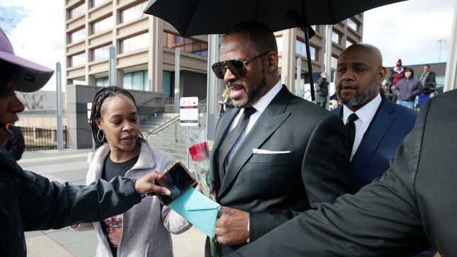 Fans giving singer R. Kelly a rose, and cards, outside the Leighton Courthouse on March 22, 2019 in Chicago, Illinois.