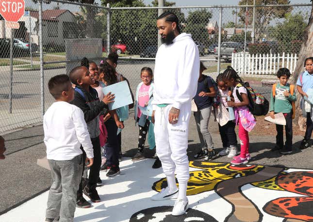 Nipsey Hussle greets kids at the Nipsey Hussle x PUMA Hoops Basketball Court Refurbishment Reveal Event on Oct. 22, 2018, in Los Angeles.