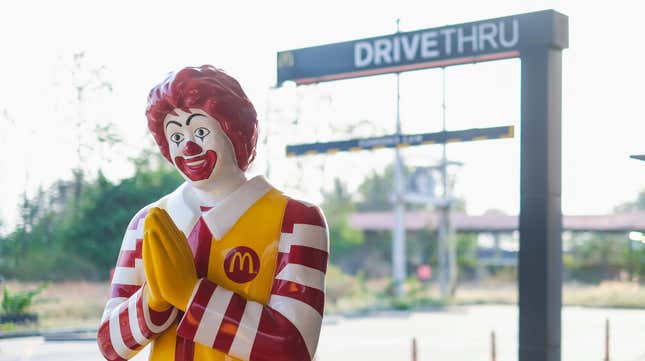 Ronald McDonald statue in front of McDonald's drive-thru