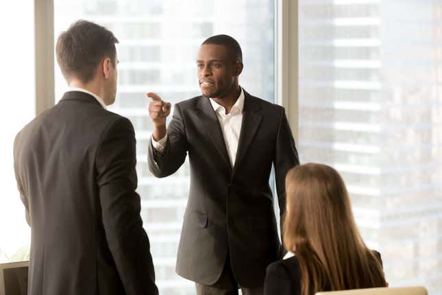 I typed the word “threaten” in the search on Shutterstock, and this is what came up. The original caption is “Angry African-American businessman threatens colleague, conflict between male workers at workplace, bullying and discrimination, black boss blames white employee responsible for failure, your fault”