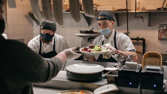 cook handing food to server