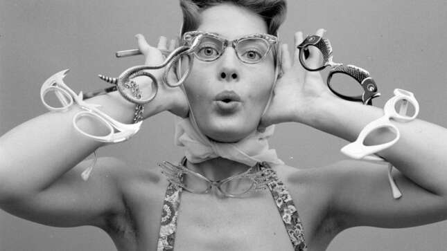 circa 1956: A model with the latest styles of spectacles.