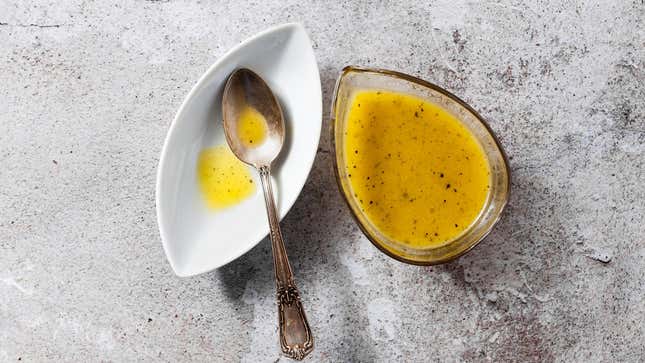 Vinaigrette in a ceramic dish on a concrete tabletop