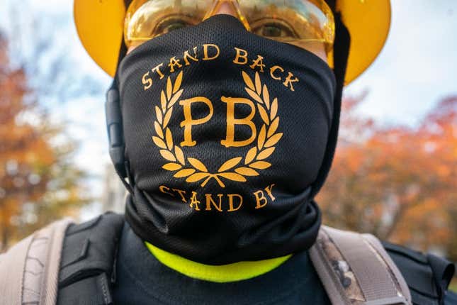 A Proud Boy displays a bandana with the phrase Stand Back, Stand By, a reference to President Trump’s statements about the group during a “Stop the Steal” rally on November 7, 2020, in Salem, Oregon. 