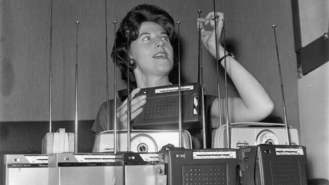 1962: A woman inspects the aerials of Floret transistor radios at the Radio Show at Earl’s Court, London.