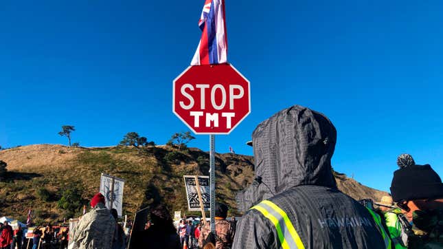 Demonstrators gather to block a road at the base of Mauna Kea in Hawaii July 15, 2019 to protest the construction of a giant telescope.