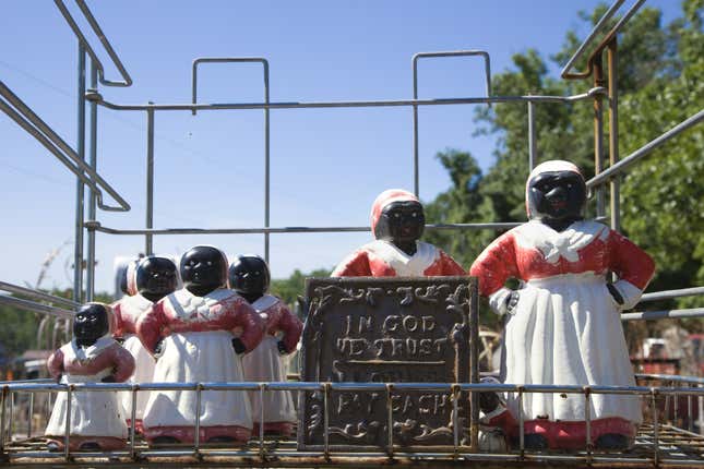 Collection of Aunt Jemima statuettes outdoors.