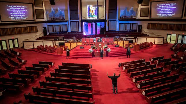 Reverend Dr. Alyn E. Waller, bottom right, leads his three-member choir from the main aisle of an empty Enon Tabernacle, during the church’s live streaming Easter Sunday Service in Philadelphia, Sunday, April 12, 2020.