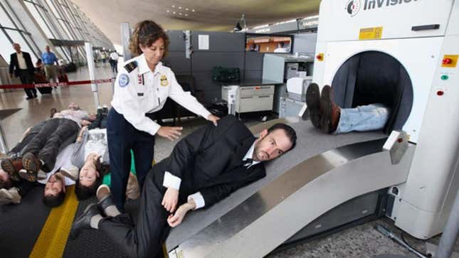A TSA officer loads in the tall stock for a routine explosives scan.