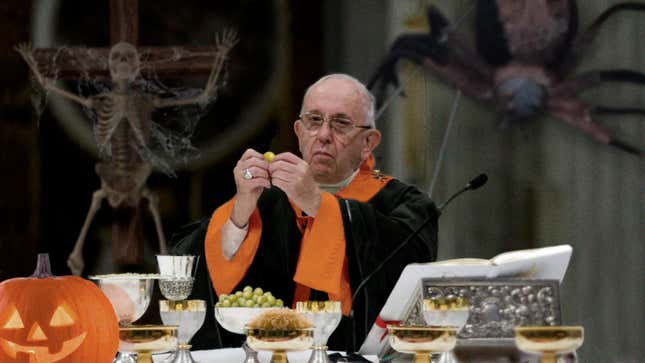 Pope Francis administers the unholy sacrament to parishioners in the Haunted House of the Lord.
