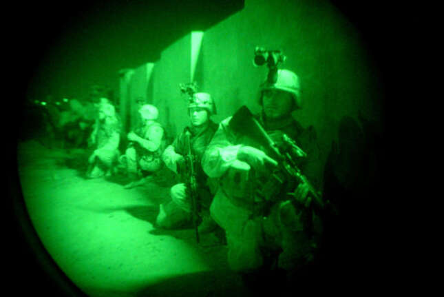American soldiers of the 1st Battalion, 22nd infantry regiment, 4th Infantry division, are seen ready to raid a suspected Saddam loyalist house in the early hours of Tuesday morning in Tikrit, Iraq, Sept. 9, 2003.