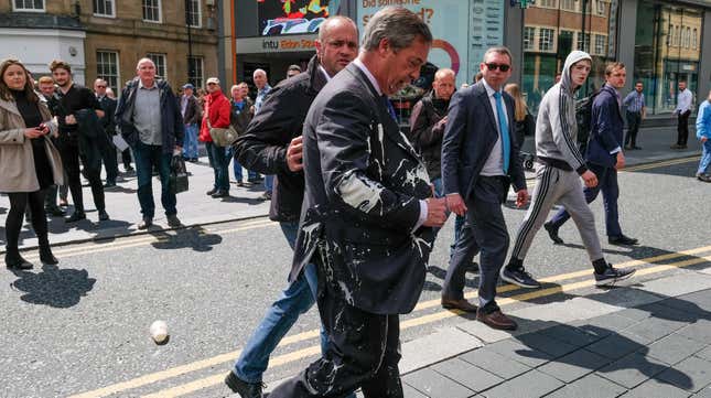 Brexit Party leader Nigel Farage has what is reported to be a milkshake thrown on him as he visits Northumberland Street in Newcastle Upon Tyne, England, on May 20.