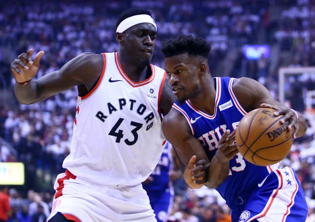 Jimmy Butler of the Philadelphia 76ers, right,  dribbles the ball as Pascal Siakam of the Toronto Raptors defends during Game One of the second round of the 2019 NBA Playoffs at Scotiabank Arena on April 27, 2019 in Toronto, Canada.