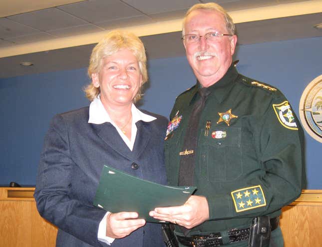 Capt. Penny Phelps, left, received a Distinguished Service Award for her work training county employees in customer relations.