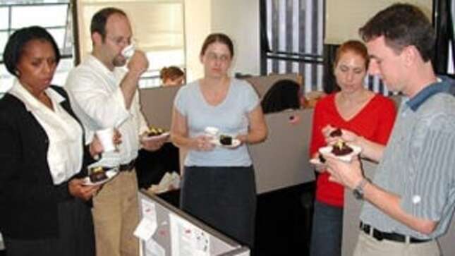 The departing Mooney (center) is surrounded by indifferent coworkers.