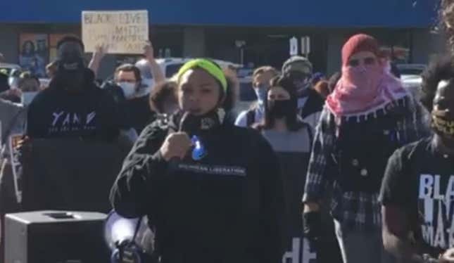 The Hall family speaks at a protest in Warren, Mich., on Sept. 19, 2020. An unidentified perpetrator threw a brick threw the window of their house and shot into their living room in an apparent hate crime.